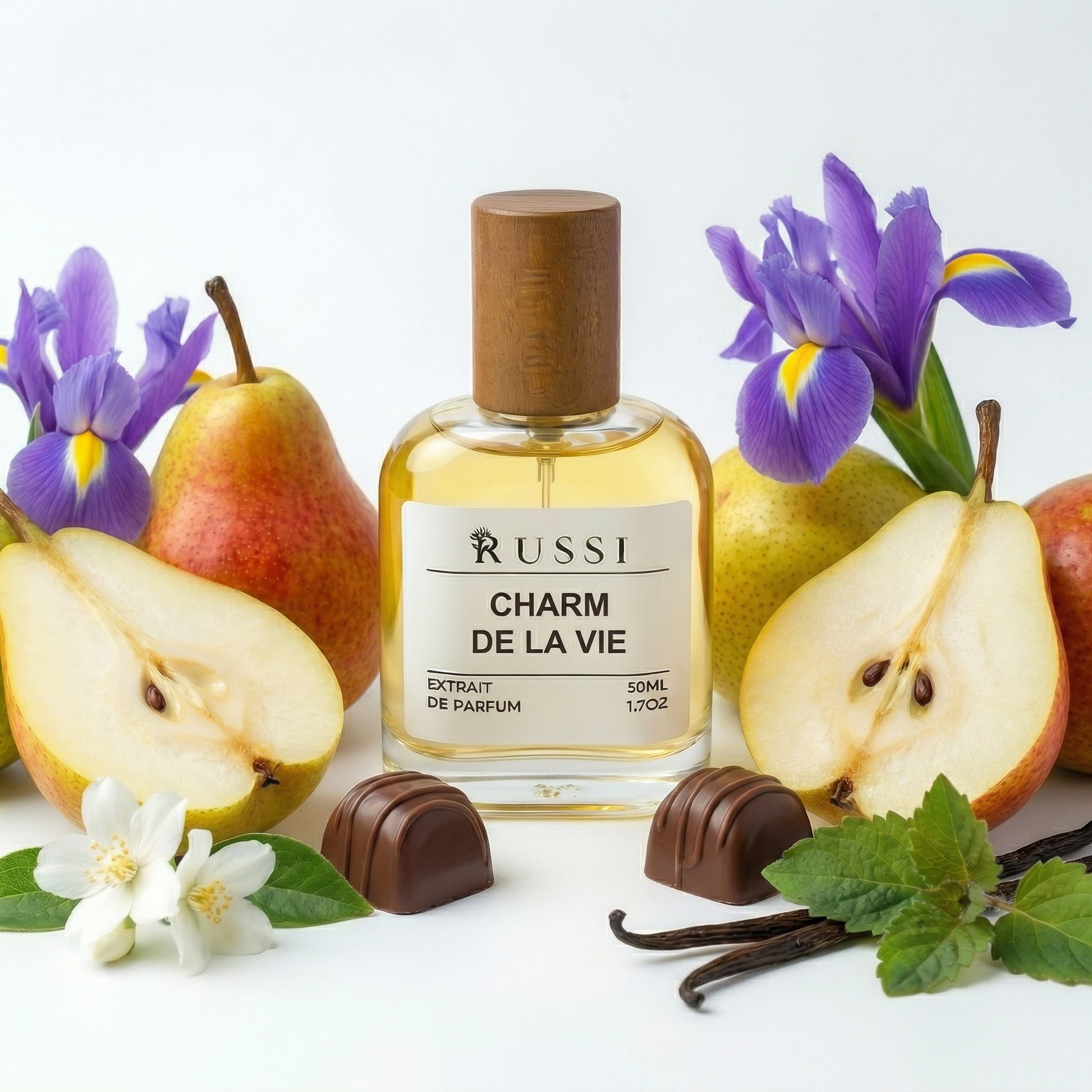 Talismanas kvepalai Charm De La Vie su kriaušėmis, gėlėmis ir vanile ant balto fono
